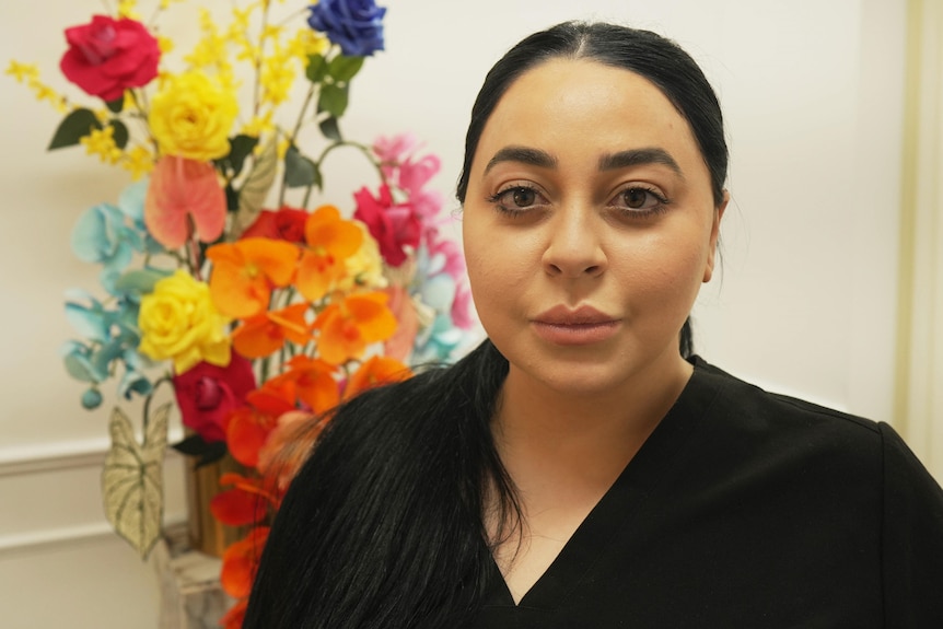 A woman wearing a black top.