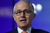 A tight headshot of Malcolm Turnbull. He is wearing an orange patterned tie.