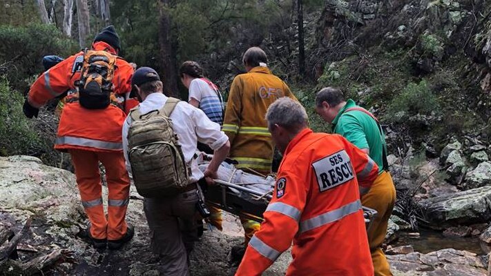 SES and volunteers carrying a man on a stretcher