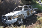 Blackened wreck of burned ute