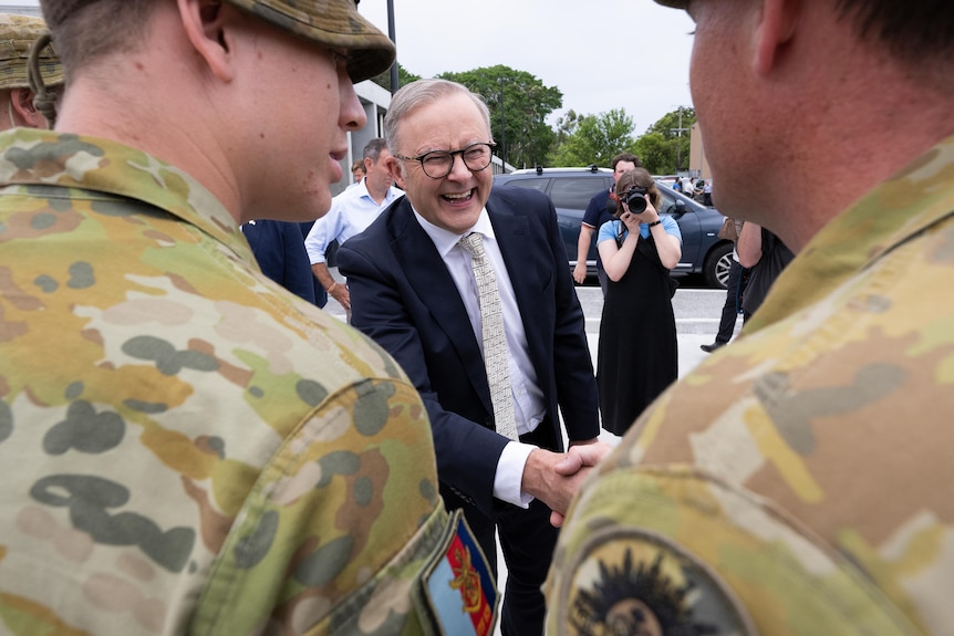 Albanese shakes hands with two ADF personel
