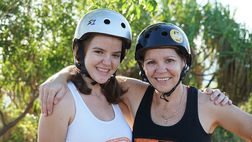 Karen and Eloise Avery wearing roller derby helmets.