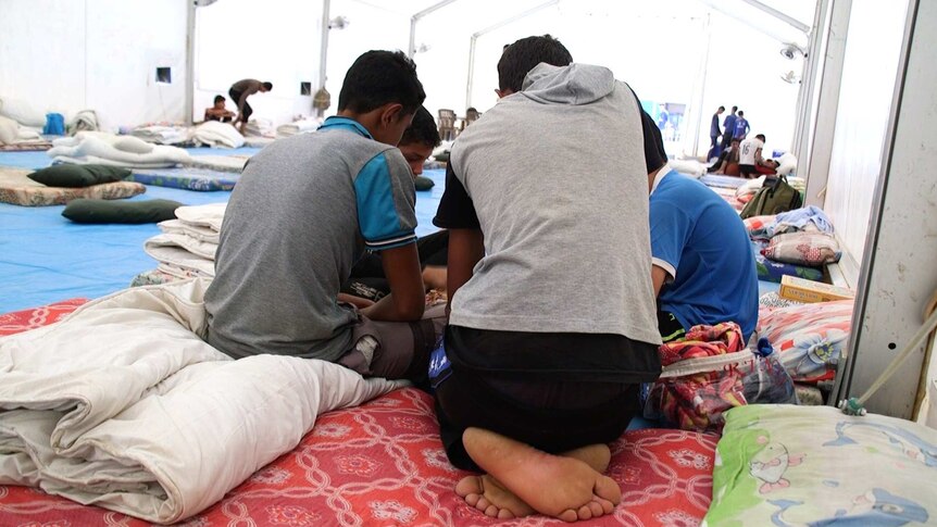 Boys sit in a tent in the Debaga refugee camp in northern Iraq.