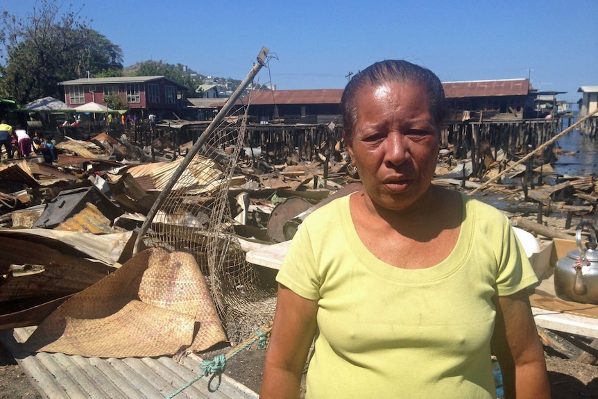 Seri Rea, a Hanuabada Village resident. She is standing in front of the debris left from the fire.
