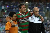 More injury woes... Sam Burgess is escorted from the field in another black night for the Rabbitohs.