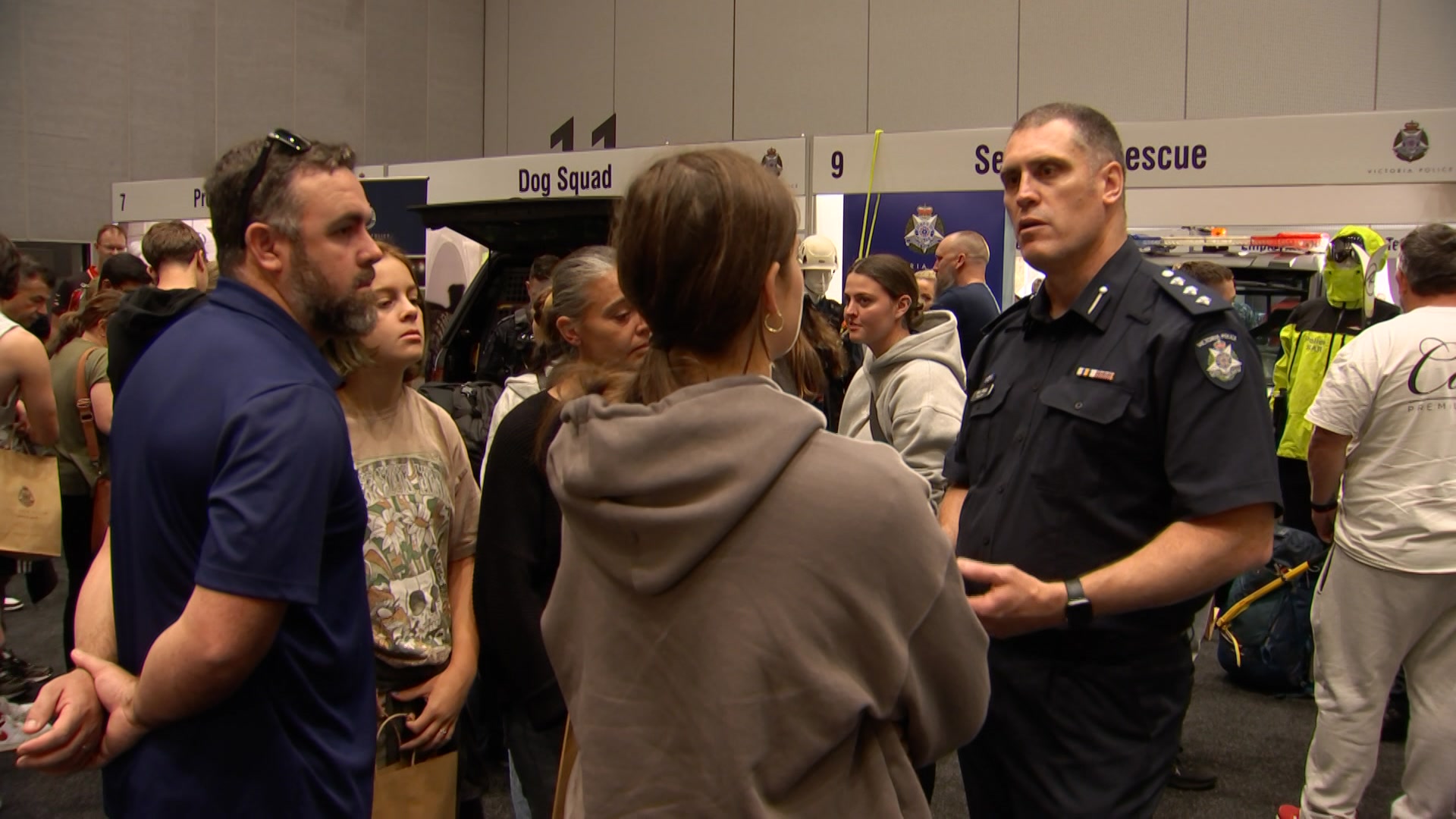 A police officer talking to several people.