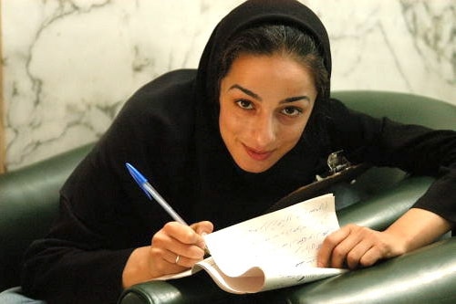 Masih in Iran's parliament writing in Farsi