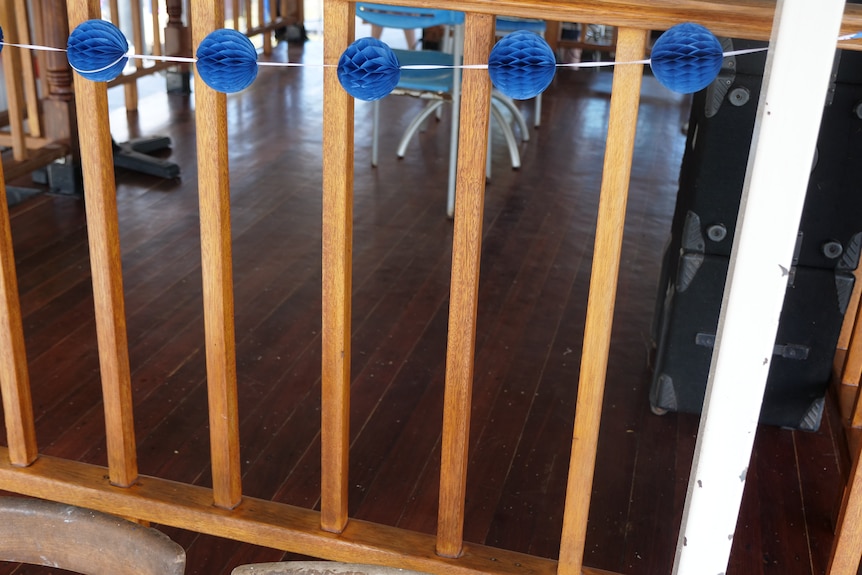 A varnished wooden dancefloor surrounding by balustrades