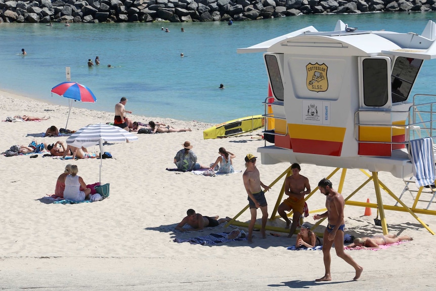 People at Cottesloe Beach during Perth's heatwave.