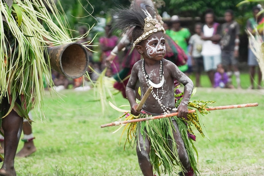 A child takes part in a performance.