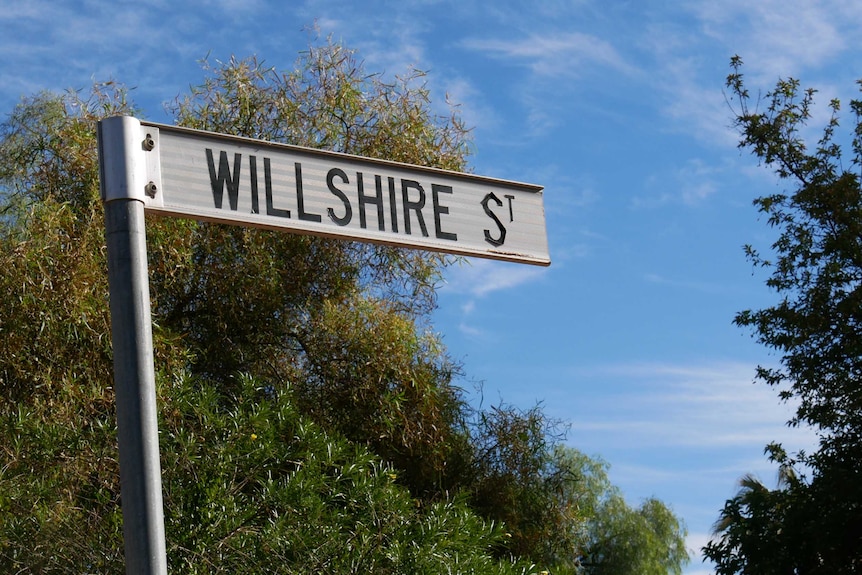 A photo of a street sign with 'Willshire' written on it