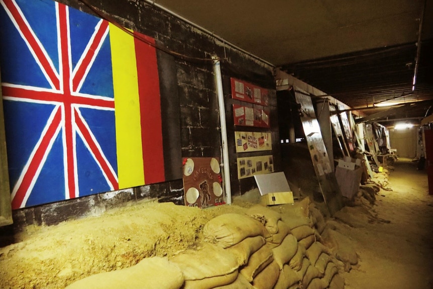 Replica WWI trench, with sandbags, painted flags and photo displays, has been excavated under the school's sports centre.