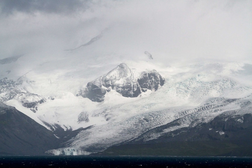 Mountains and snow in a cold, grey landscape