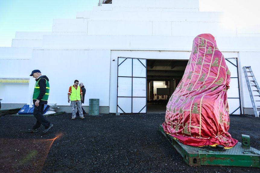 The giant Jade Buddha covered in a pink cloth embossed with golden buddhas.