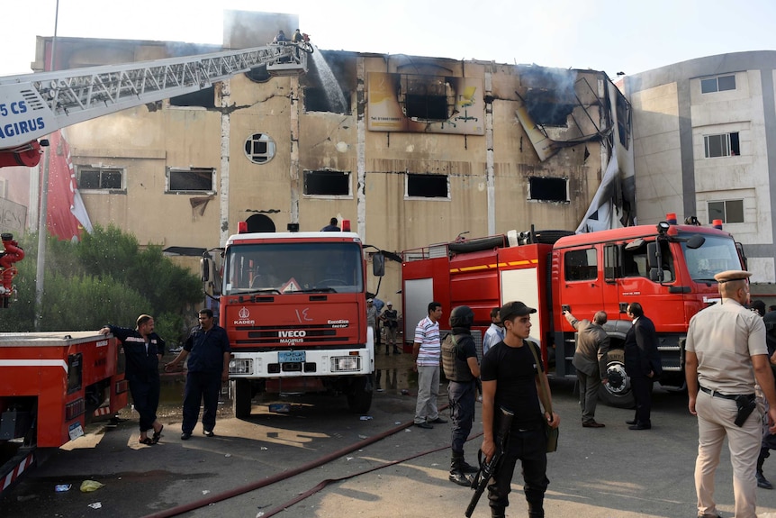 Egyptian firemen put out the flames at the Al-Helw furniture factory