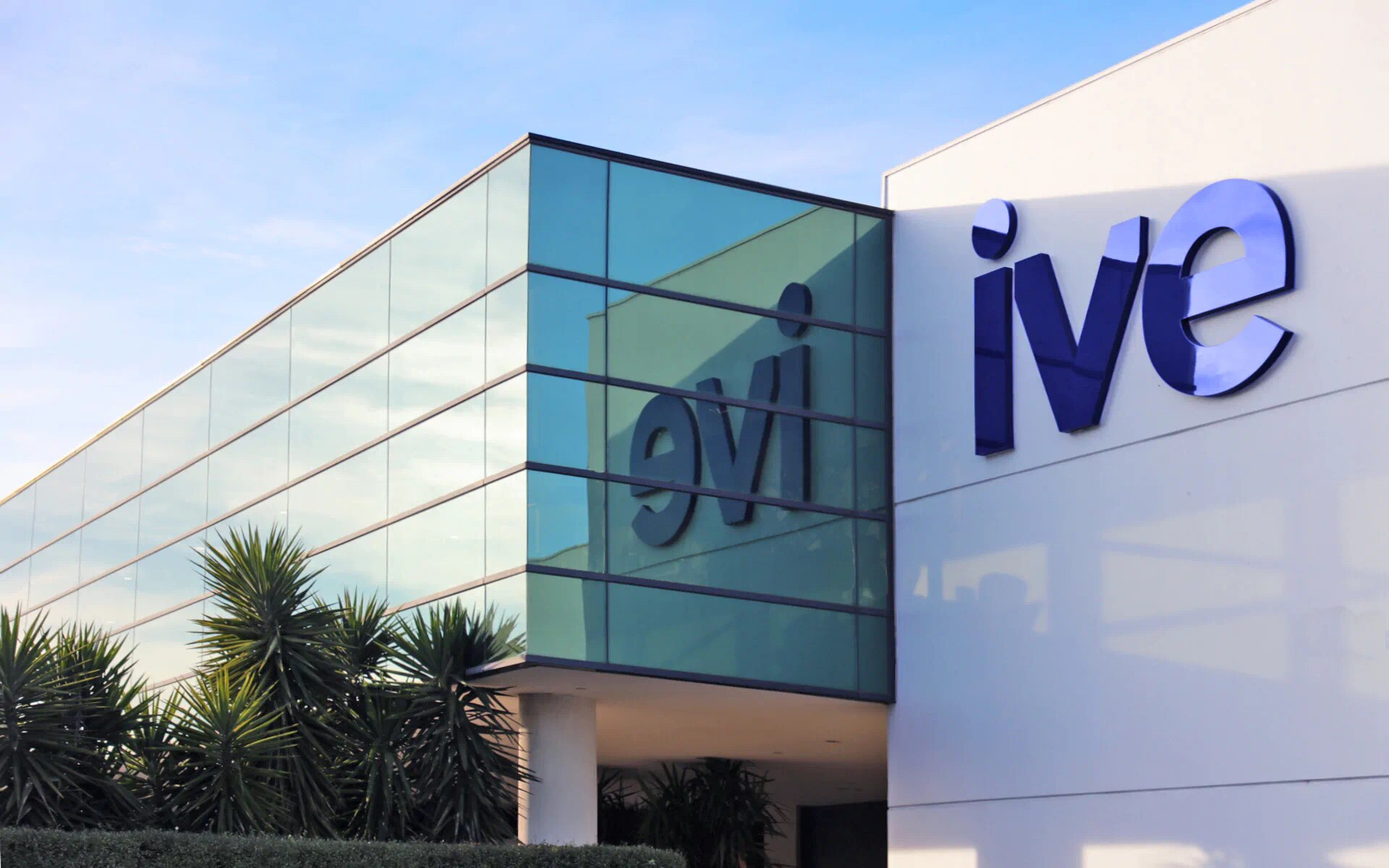 A glassy building with a blue logo which reads IVE