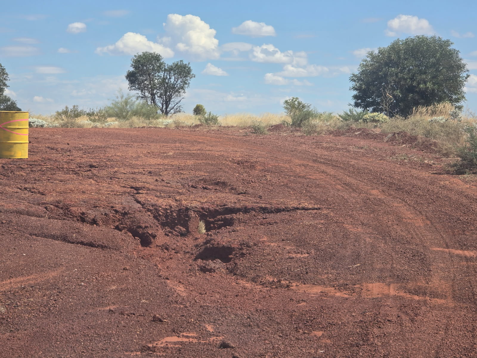 A weather damaged unsealed road.