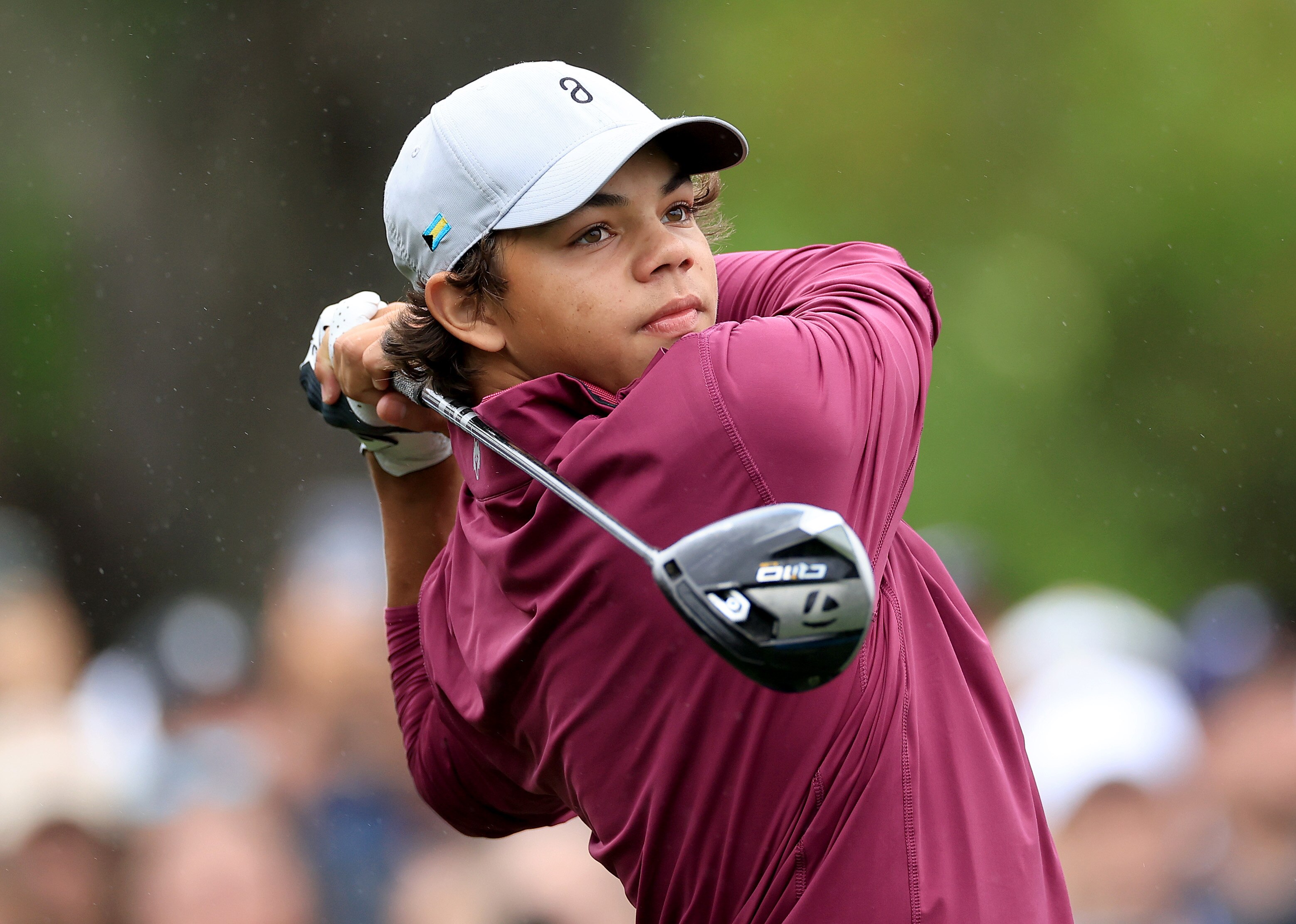 Charlie Woods plays a tee shot at a 2023 tournament.
