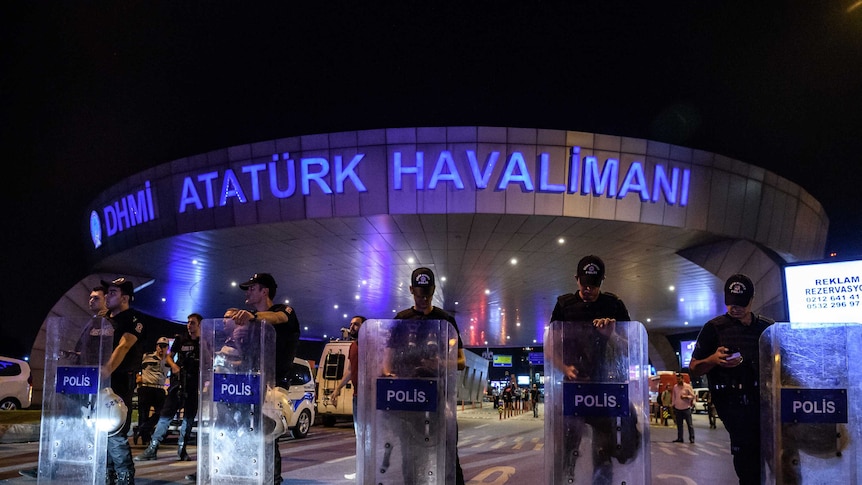 Turkish anti riot police officers block the main entrance with shields