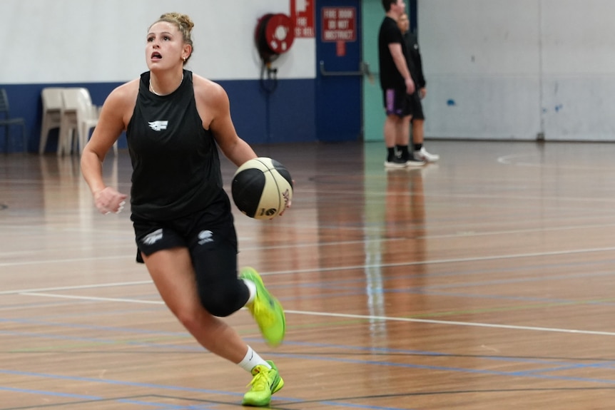 Full length shot of Tiana Mangakahia dribbling the ball in training