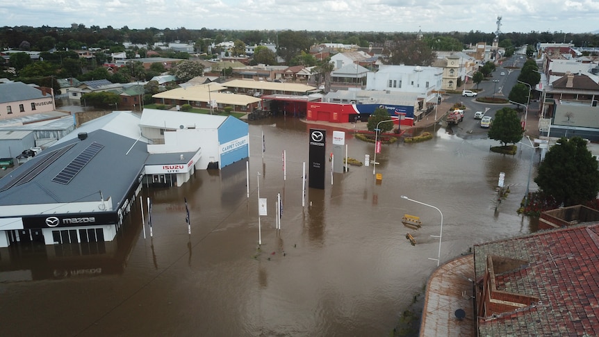 A drone image showing floodwater in the town of Forbes, with buildings surrounded by water