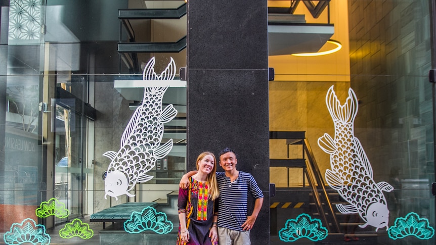 Artists Elysha Rei and Vanghoua Anthony Vue standing in front of the Japanese cut outs in Eagle Lane, Brisbane.