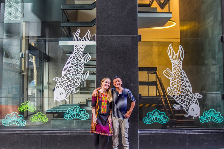 Artists Elysha Rei and Vanghoua Anthony Vue standing in front of the Japanese cut outs in Eagle Lane, Brisbane.