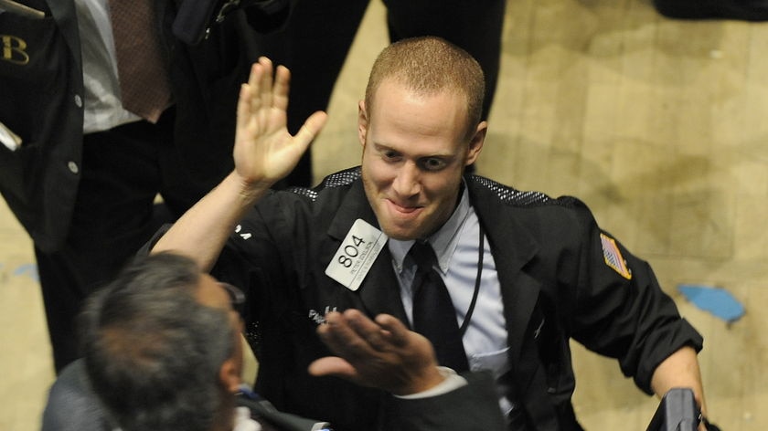 Traders celebrate on the floor of the New York Stock Exchange