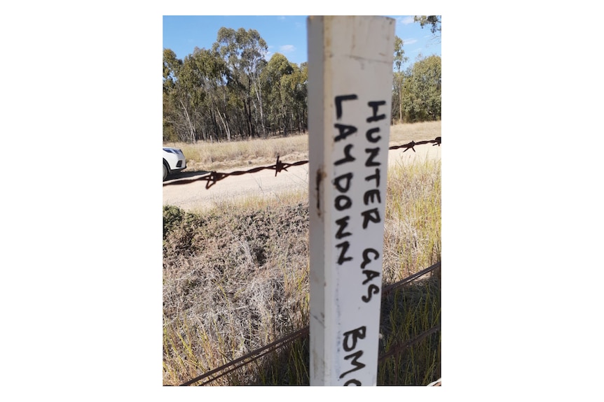 A survey peg with with writing saying "Hunter Gas Laydown".
