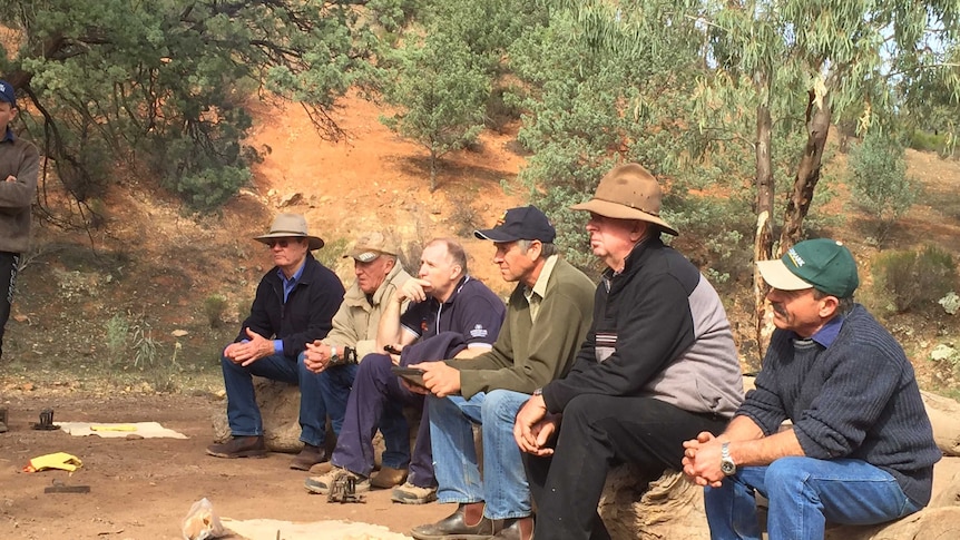 A group of Flinders Ranges graziers listen to a dog trapping presentation.
