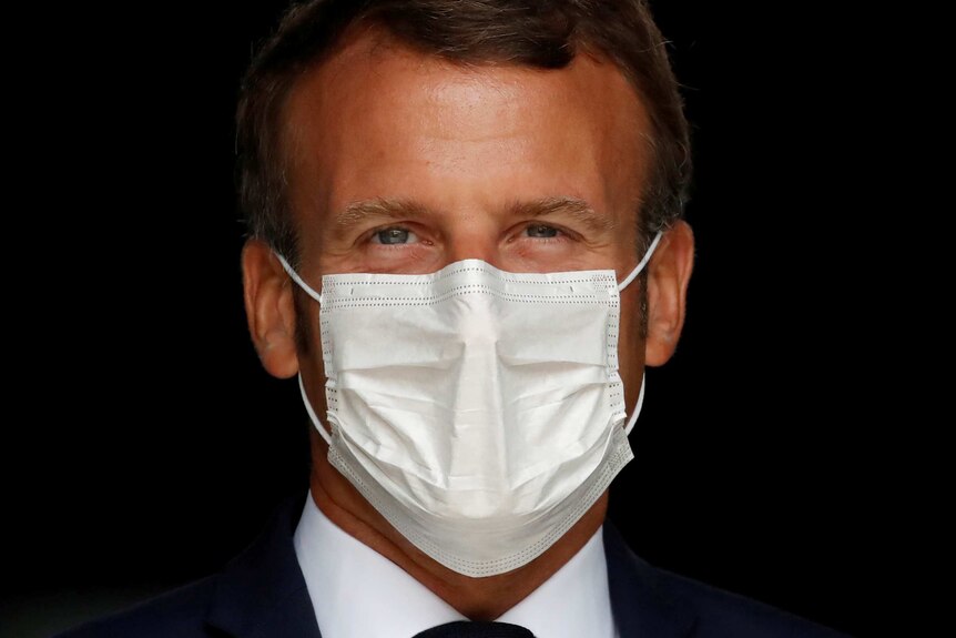 Emmanuel Macron in a white face mask