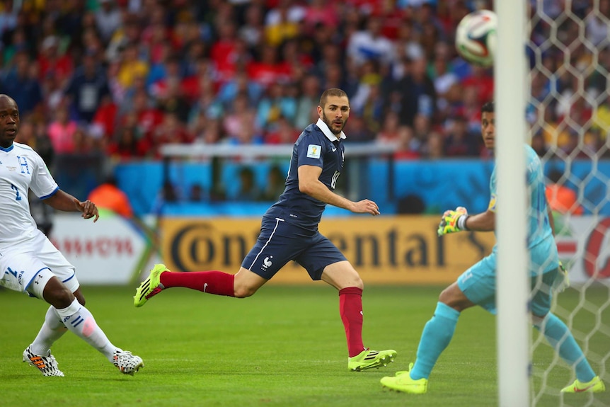 Karim Benzema sends the ball towards goal for France's second