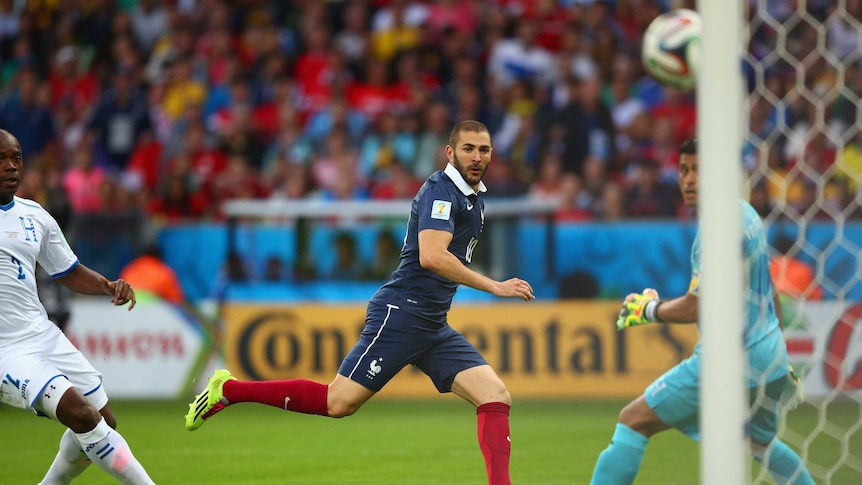 Karim Benzema sends the ball towards goal for France's second