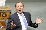 Opposition Leader Tony Abbott raises his hands in question time