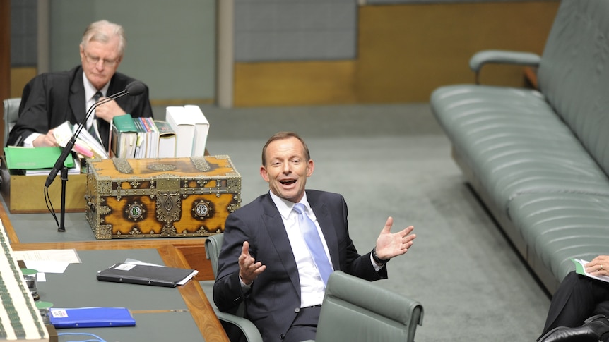 Opposition Leader Tony Abbott raises his hands in question time