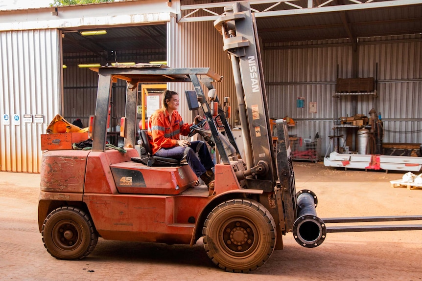 Woman driving forklift