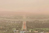 Dust obscures the view of Canberra from up high.