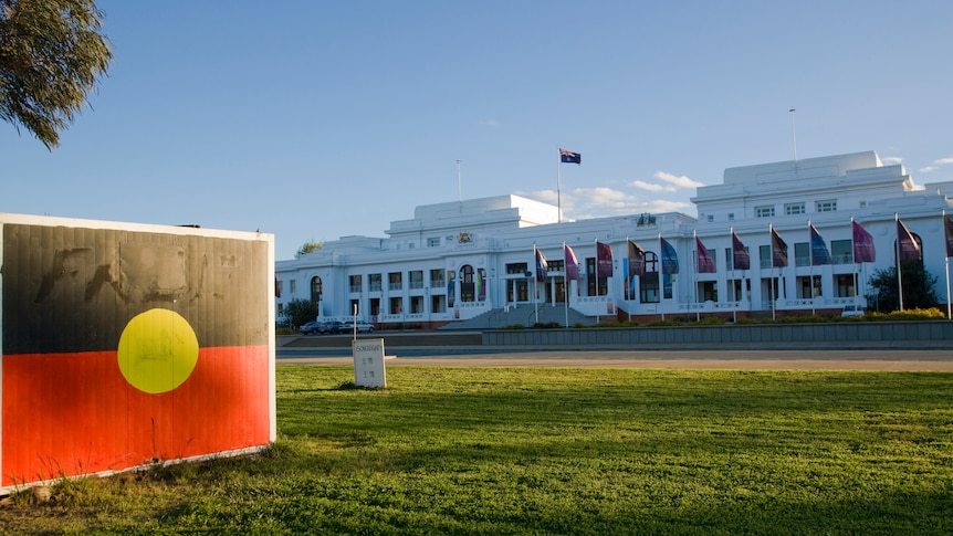 Aboriginal Tent Embassy showing the Aboriginal flag, with Old Parliament House in the background