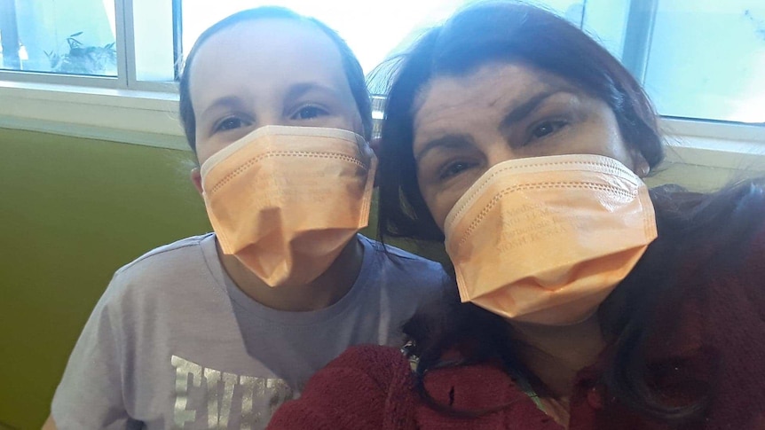 Linny Carney and daughter Taylor wearing masks.