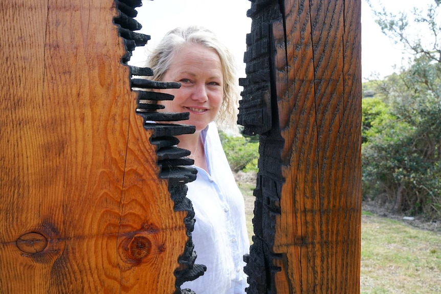 Artist Tania McMurtry looking through her sculpture