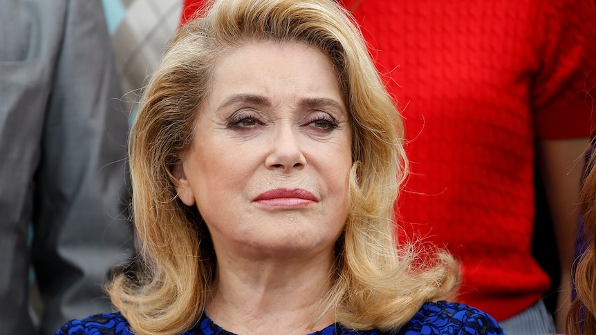 A head shot of Catherine Deneuve, who looks right of the camera.