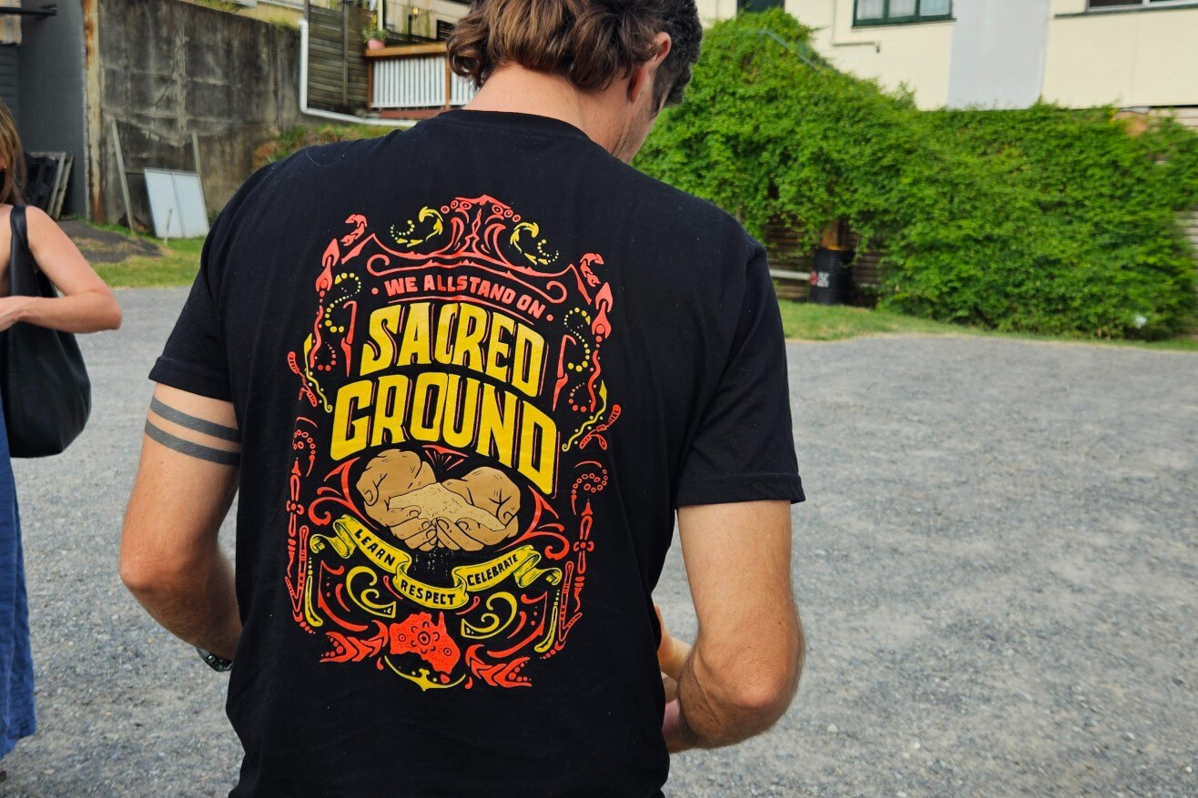 man wearing sacred ground tee crop