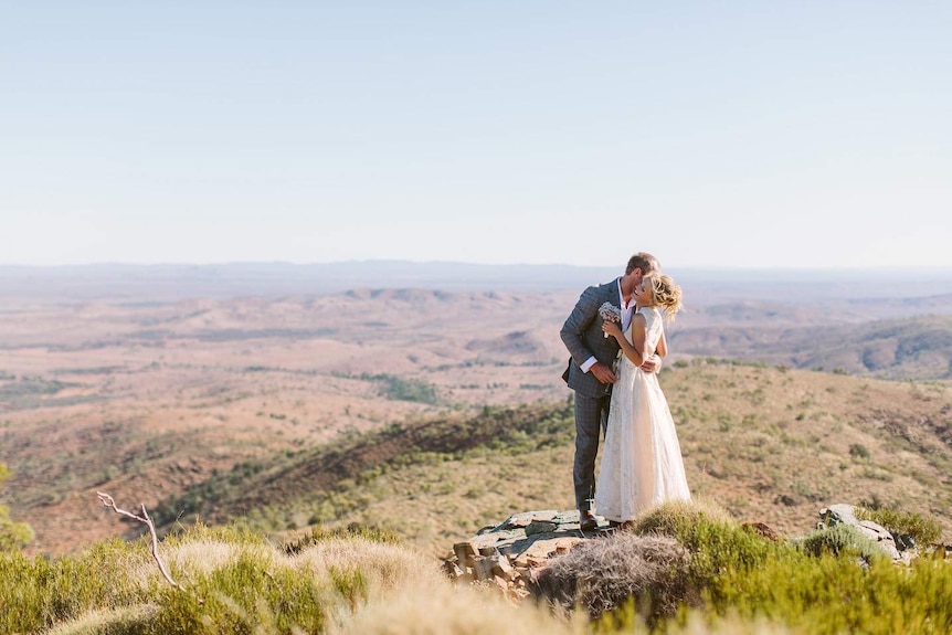 A photo of a bride and groom on a clifftop at a rural property