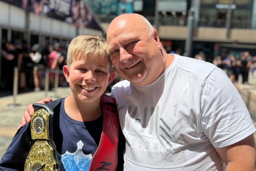 son and father with WWE merchandise 