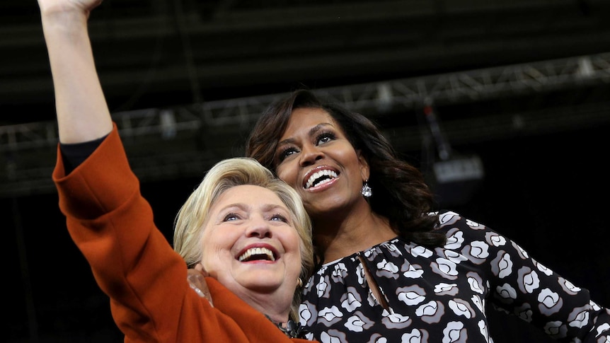 Hillary Clinton is accompanied by Michelle Obama at campaign rally