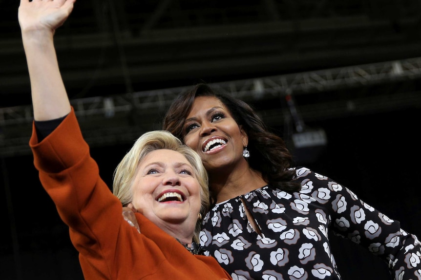 U.S. Democratic presidential candidate Hillary Clinton arrives to a campaign rally accompanied by U.S. first lady Michelle Obama in Winston-Salem, North Carolina