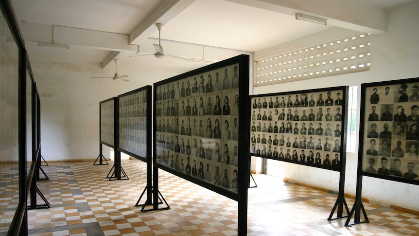 Rows of black and white photographs in a room.