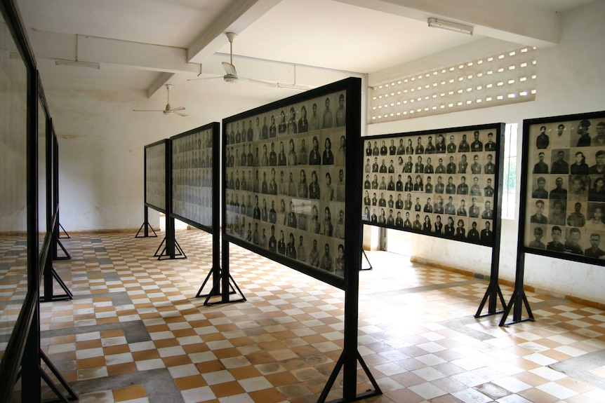 Rows of black and white photographs in a room.