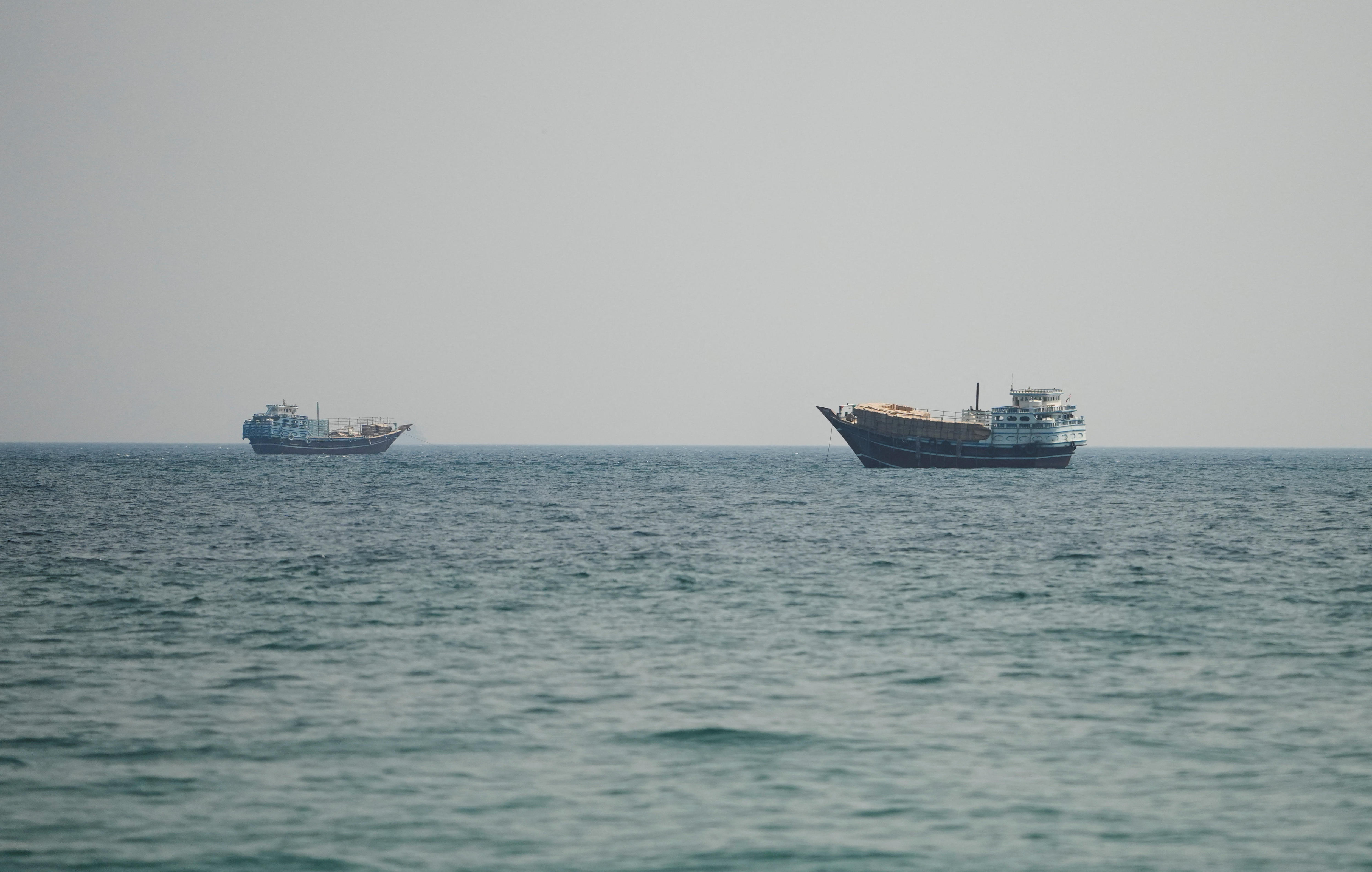 Two ships in the Strait of Hormuz, seen from Oman.