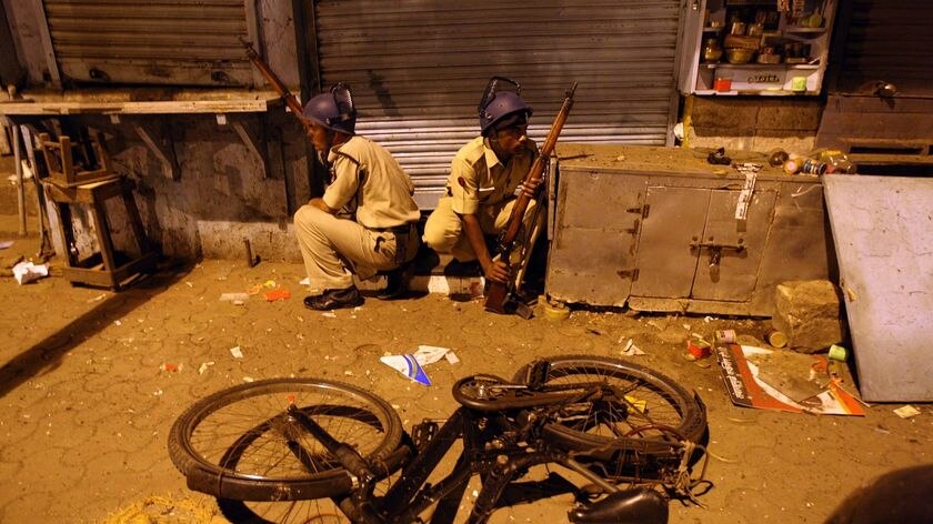Indian policemen prepare to take position at the site of an attack in the Colaba area of Mumbai